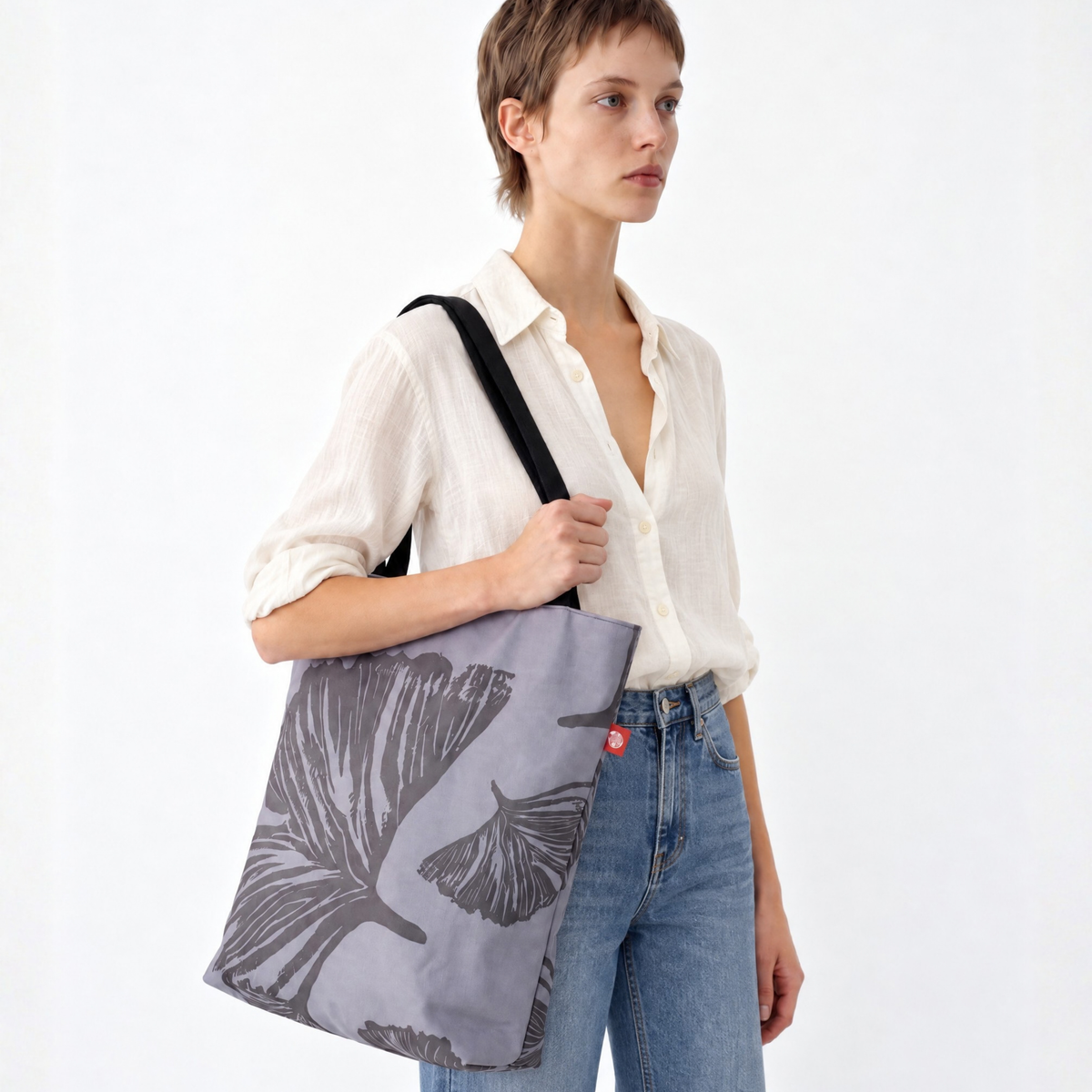 Gaia Shoulder Carry Tote in Evening Ginkgo, casually dressed model in carrying tote on shoulder