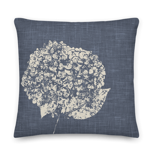 Close-up view of a blue linen pillow with a hydrangea pattern